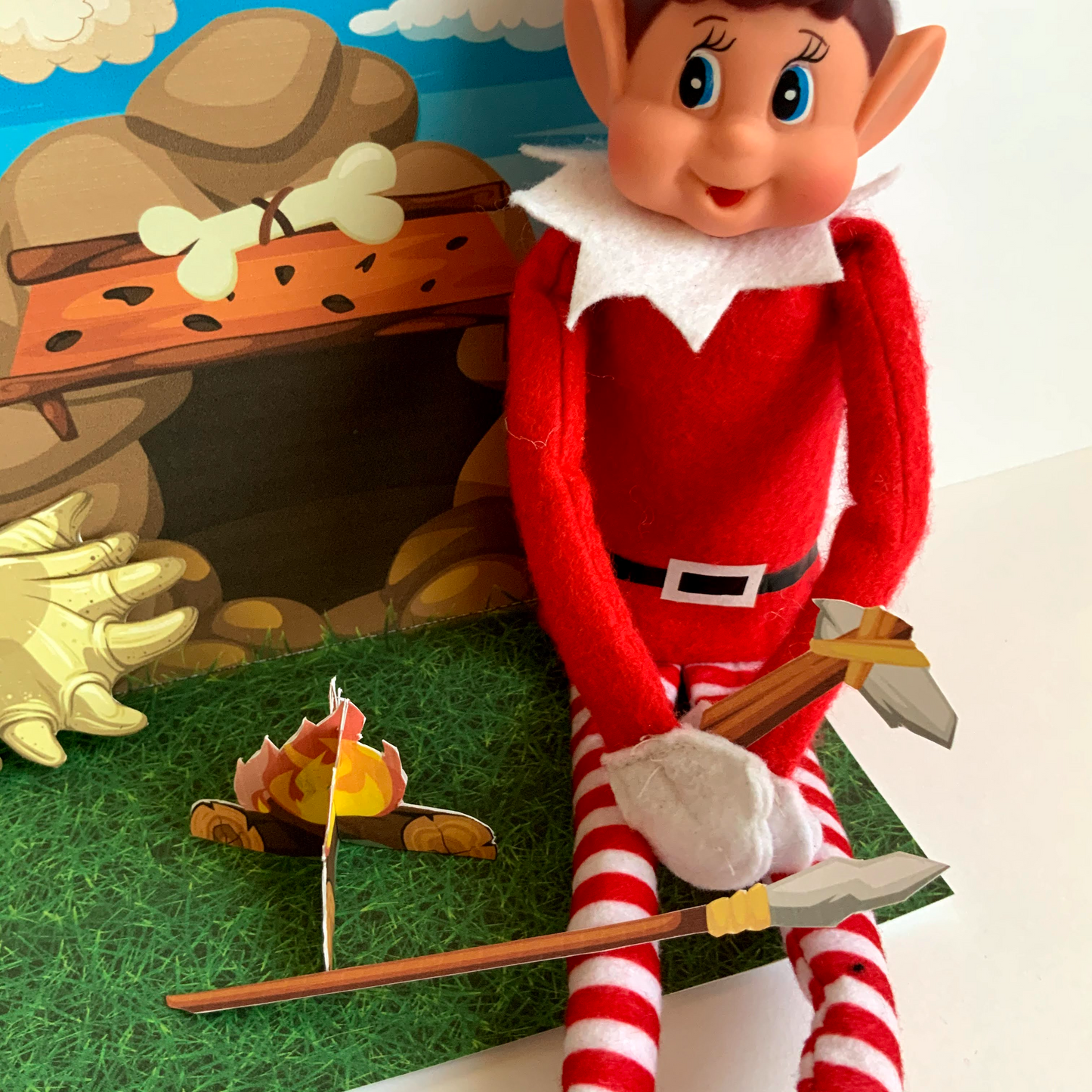 an elf sat in a caveman scene