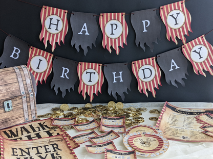 Pirate-themed birthday party decorations with 'Happy Birthday' banner, gold coins, and wooden barrel.