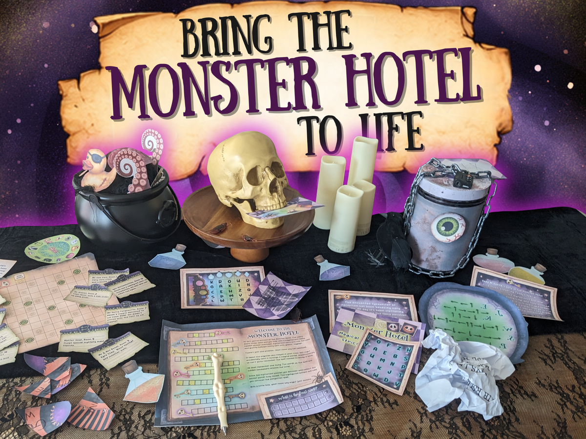 A tabletop display for a themed game or activity set under a large parchment-style sign reading 'BRING THE MONSTER HOTEL TO LIFE.' Visible items include a black cauldron with tentacles and halloween rubber duck, a skull on a stand, several white candles, a gray jar with a green eye label, cards, papers, and other printed game pieces arranged on a dark cloth against a purple starry background.