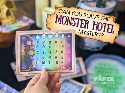 A hand holds a printed card with a colorful alphabet grid and decorative border, with a large overlaid banner reading 'CAN YOU SOLVE THE MONSTER HOTEL MYSTERY?' and a 'LOCK PAPER ESCAPE' logo in the corner. The scene appears to be a themed party or game setup with blurred props in the background.